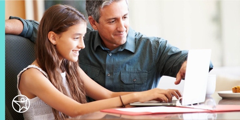A learning coach helping his daughter create an online school schedule