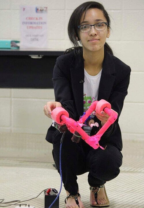 Madison holding a pink electronic device 