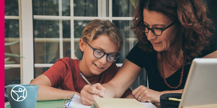 A mother helping her son with online school work