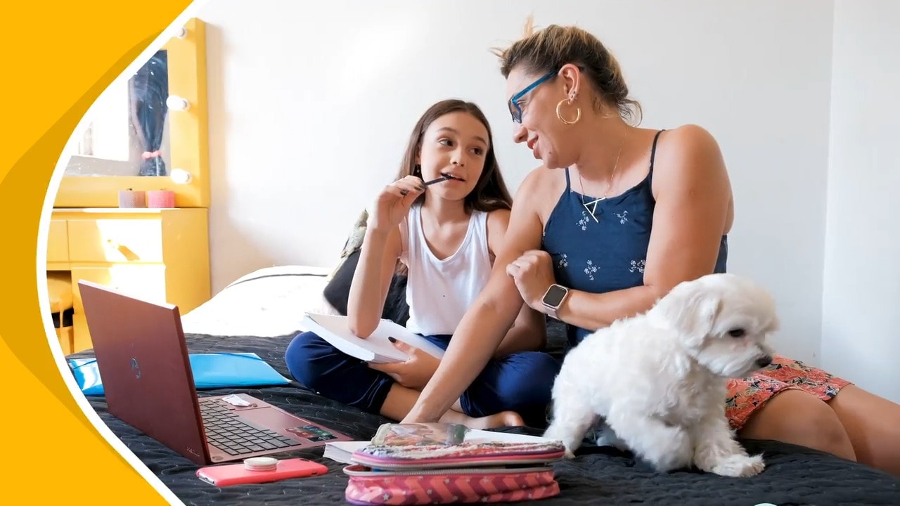 A young student and her learning coach mom working on an online class