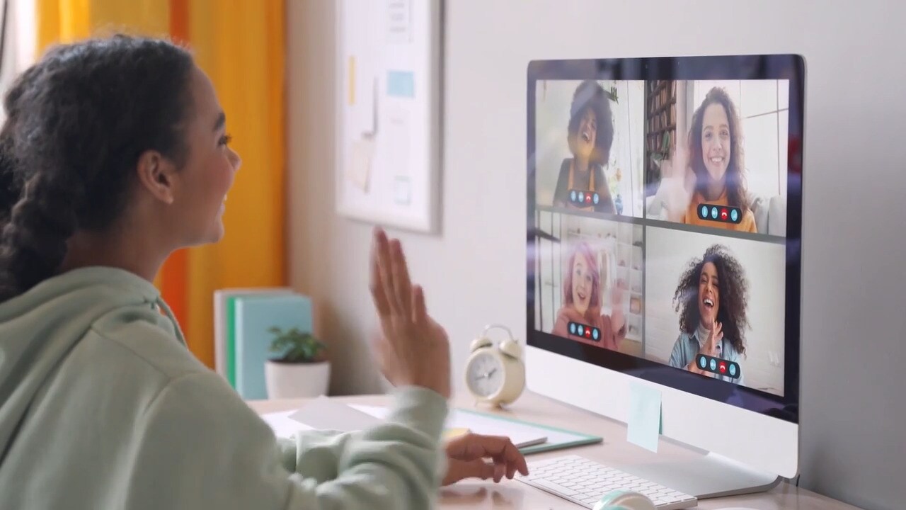 Young teen in a blue sweat shirt waving at her teachers